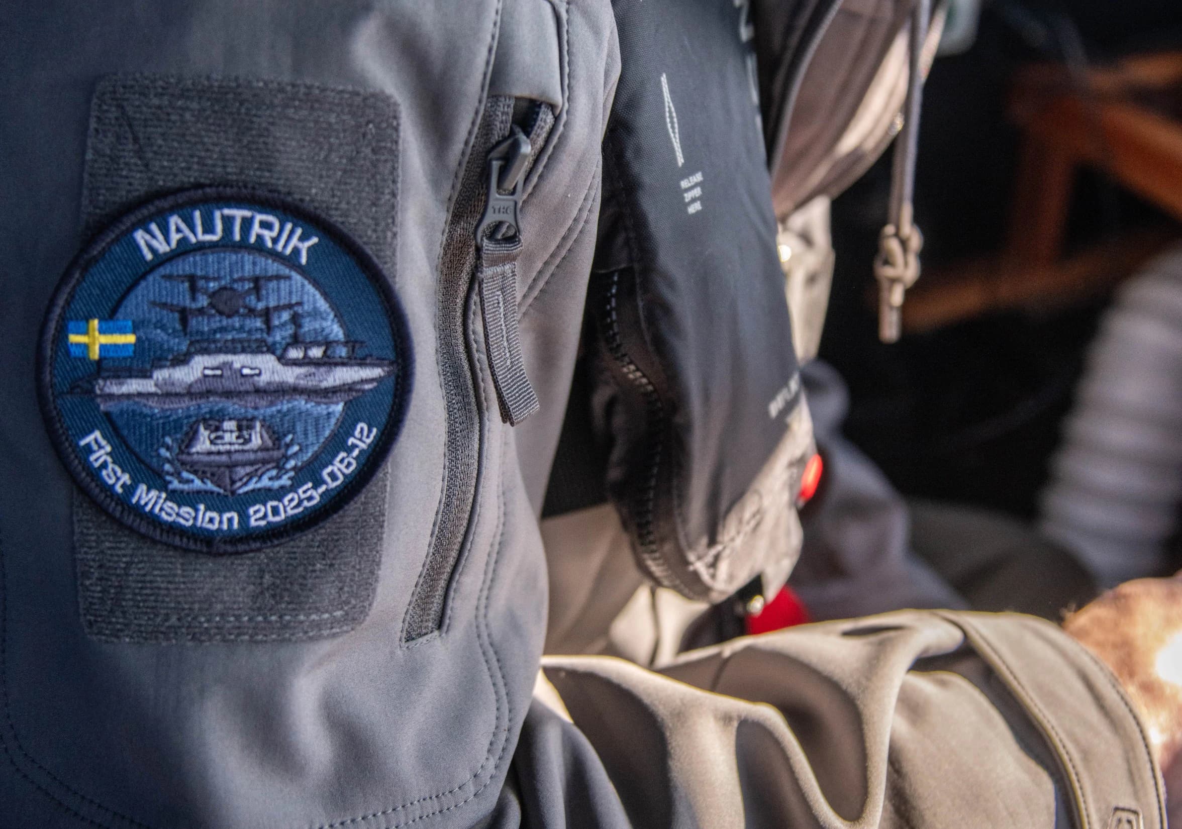 Nautrik First Mission 2025 patch on an operator’s jacket sleeve