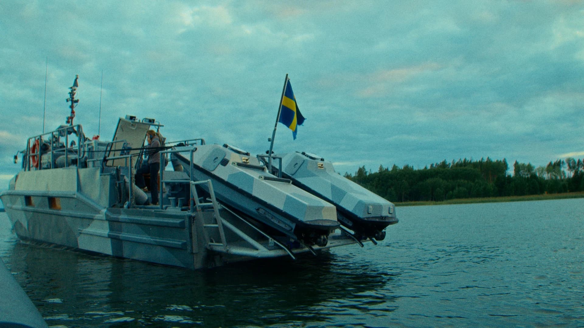 Nautrik crew boarding a camouflaged vessel carrying two autonomous surface vessels