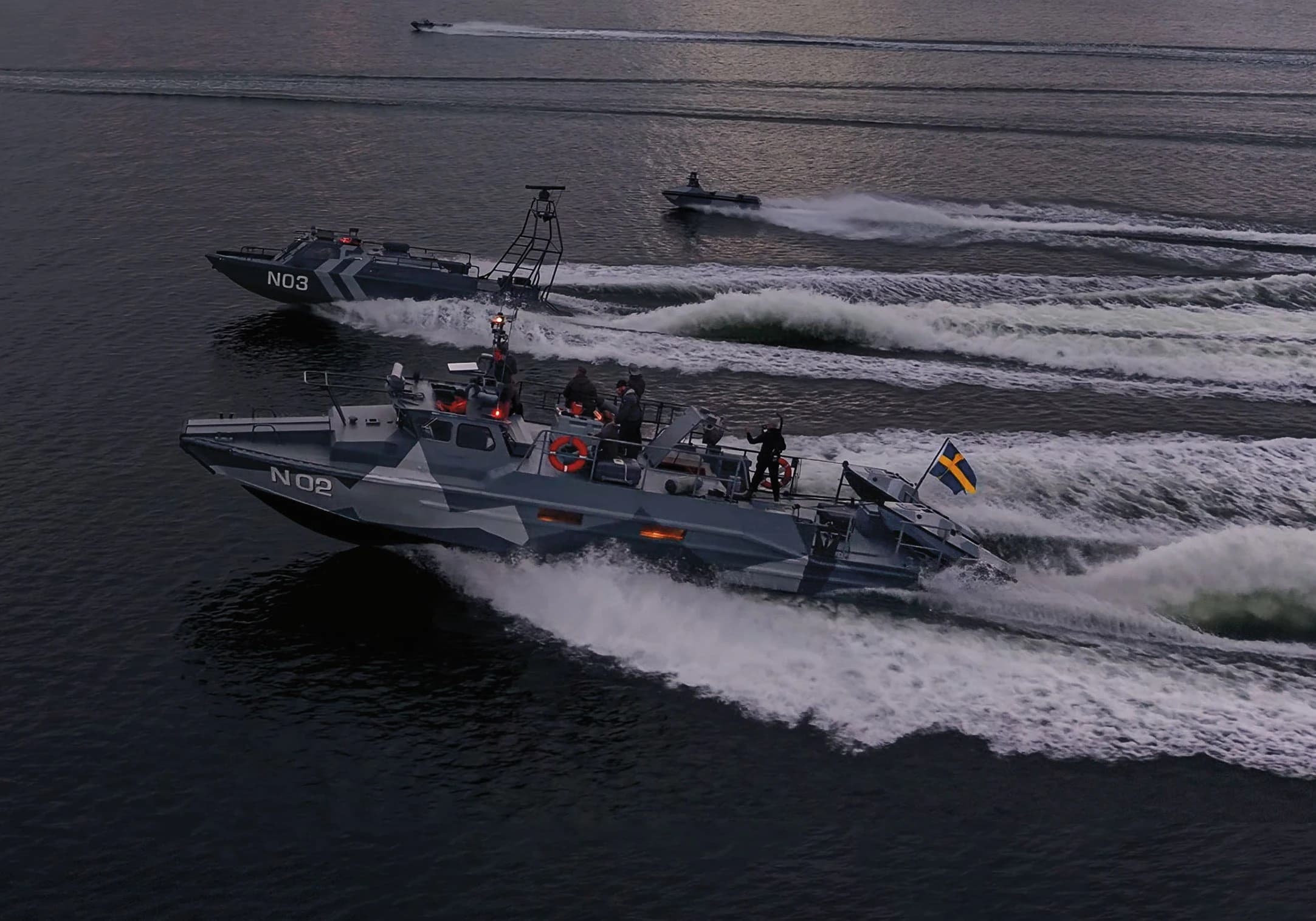 Two camouflaged Nautrik vessels running side by side at speed